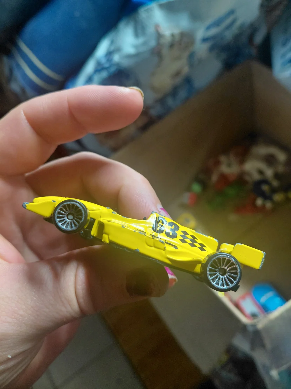 toy is a yellow and black diecast Maisto Indy Racing League #63 race car featur